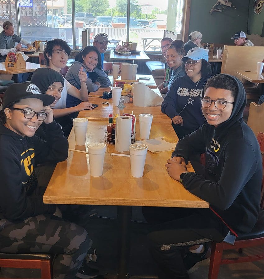 A group of people sitting at a table with drinks.