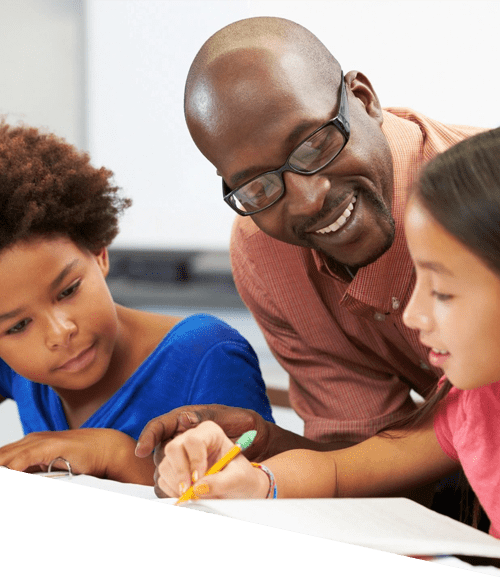 A man and two children are writing on paper.