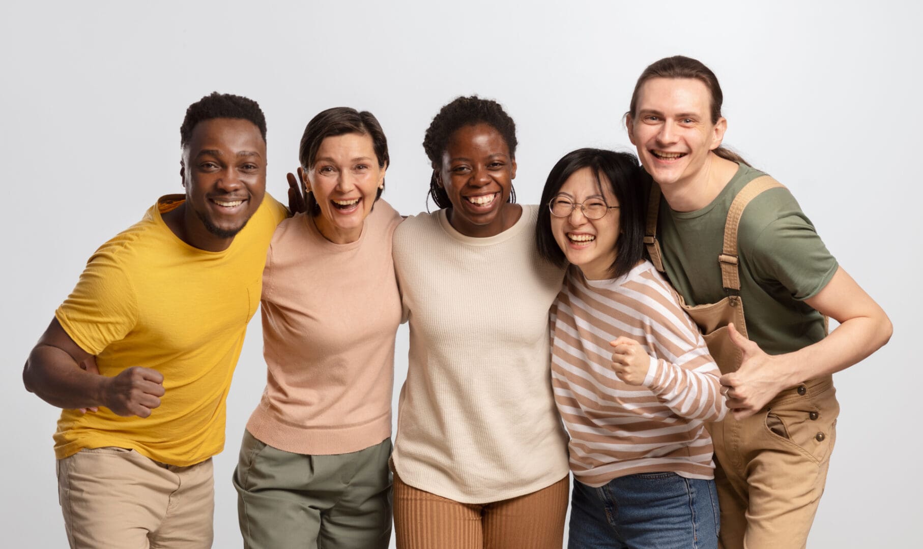 A group of people standing together smiling for the camera.